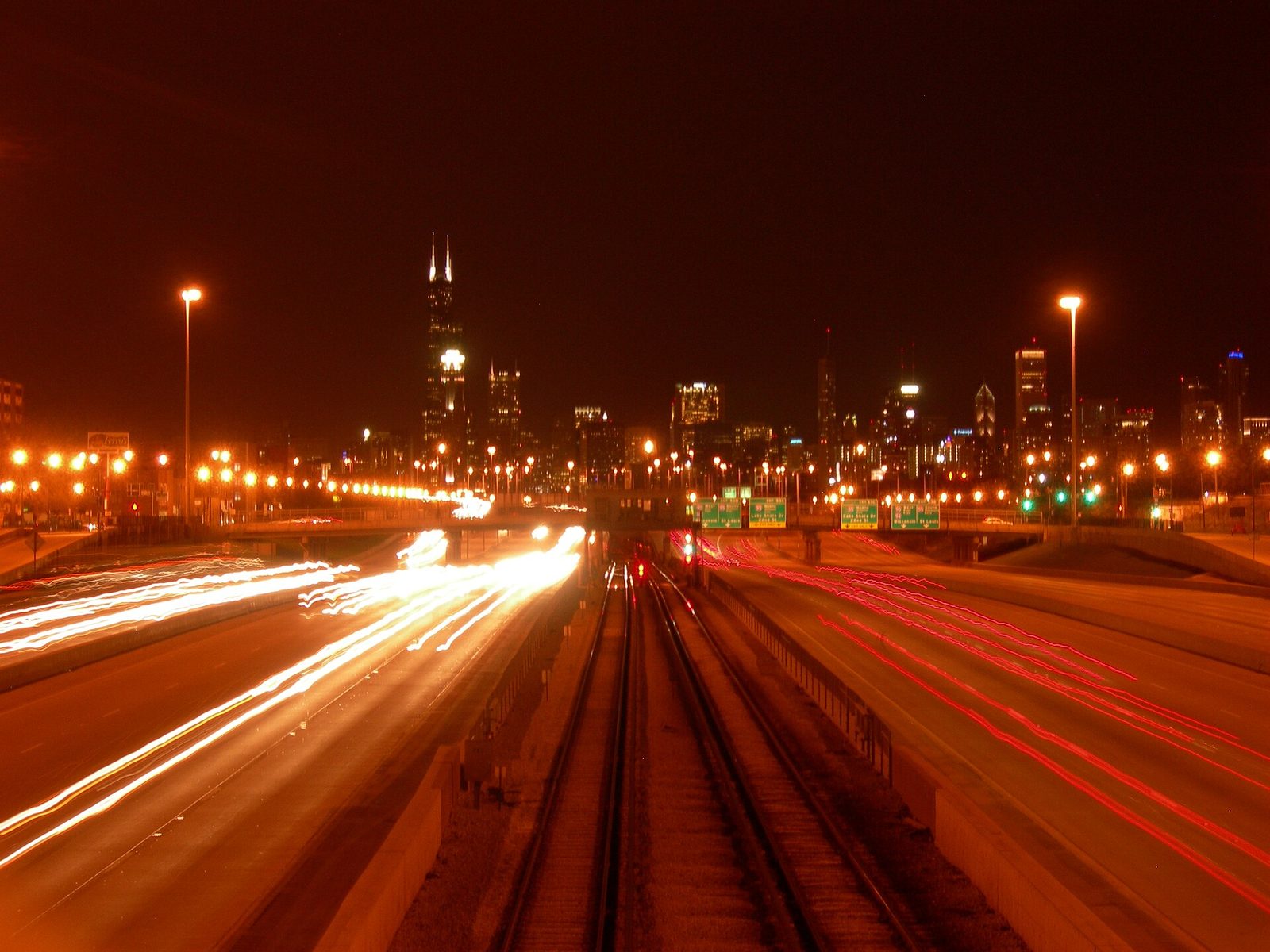 A city expressway at night, traffic streaming under the lights