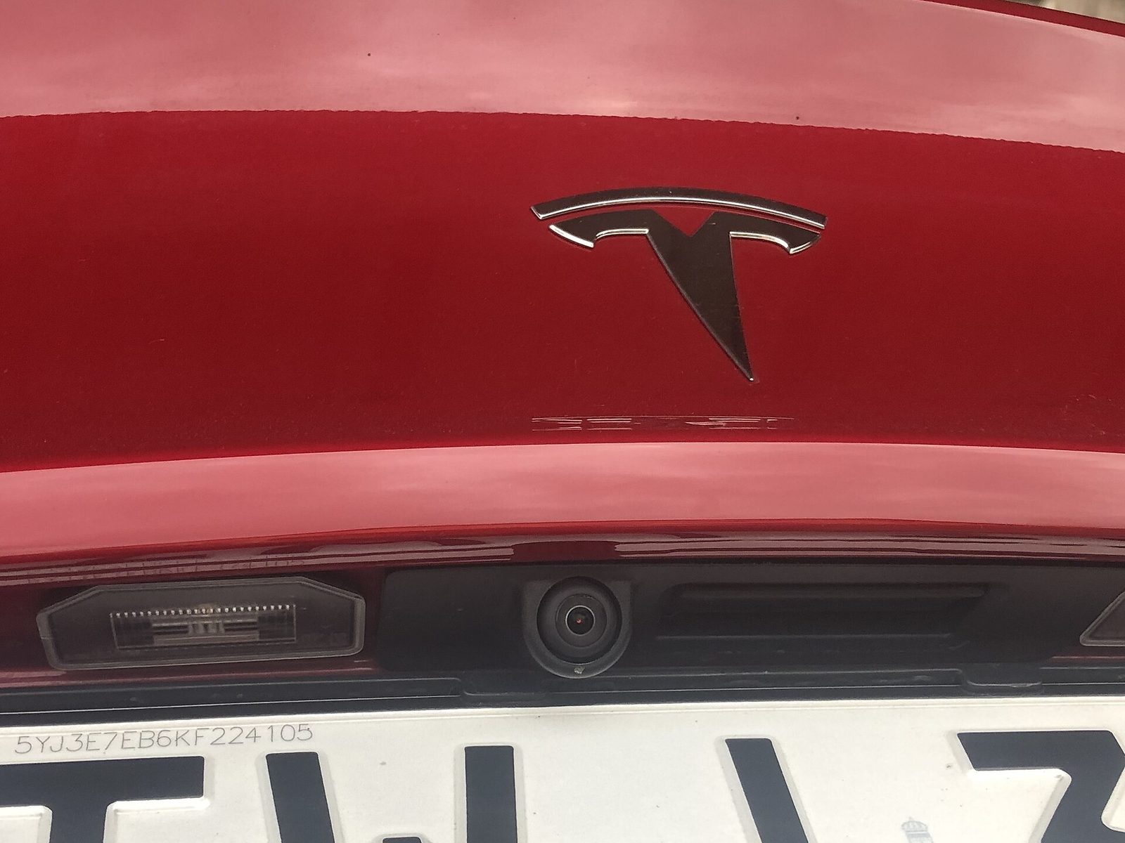 Close-up of the rear-facing camera above the number plate of a Tesla Model 3